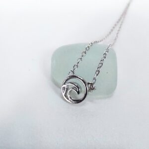 Silver surf wave necklace on beach glass